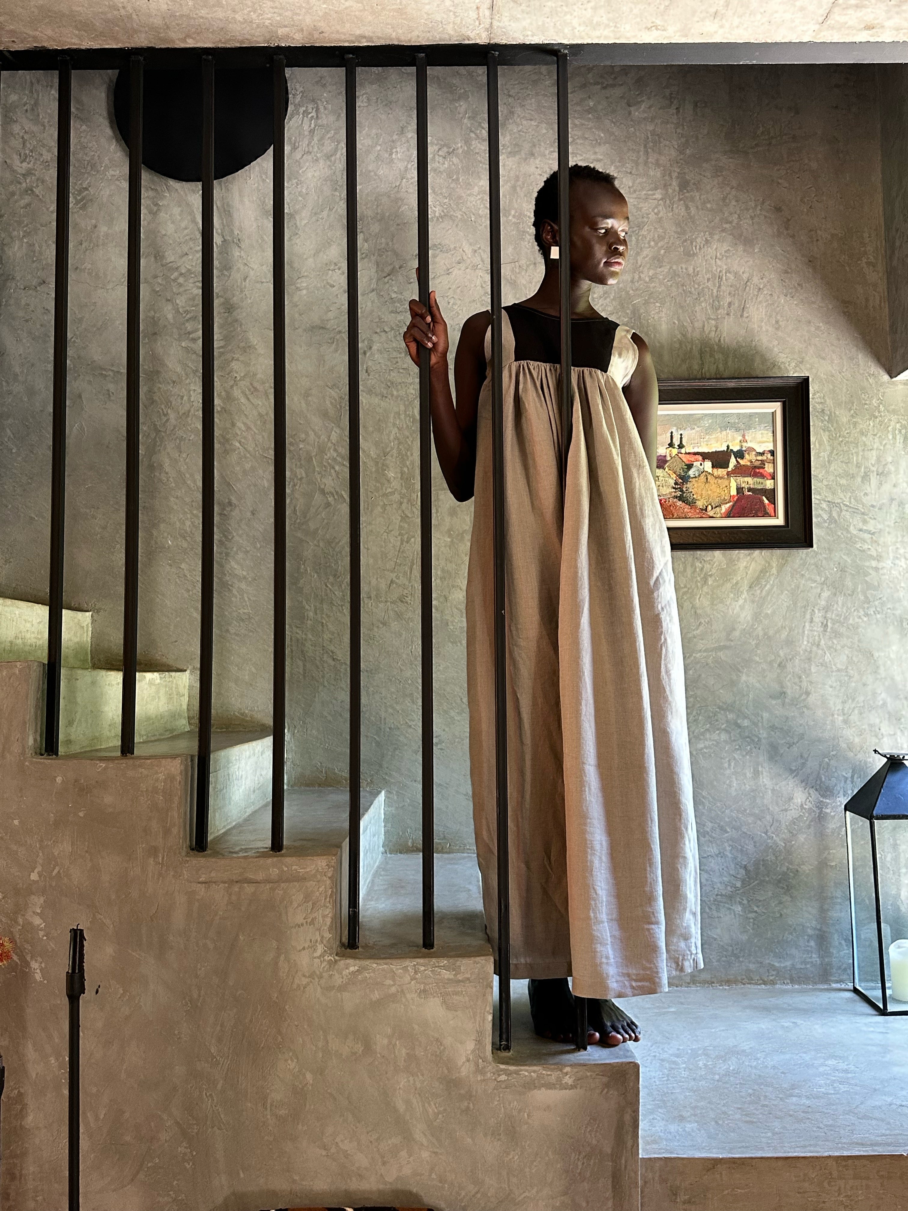Model wearing Butterfly Linen dress standing on staircase