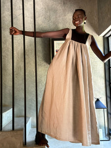 Model wearing Butterfly Linen dress standing on staircase