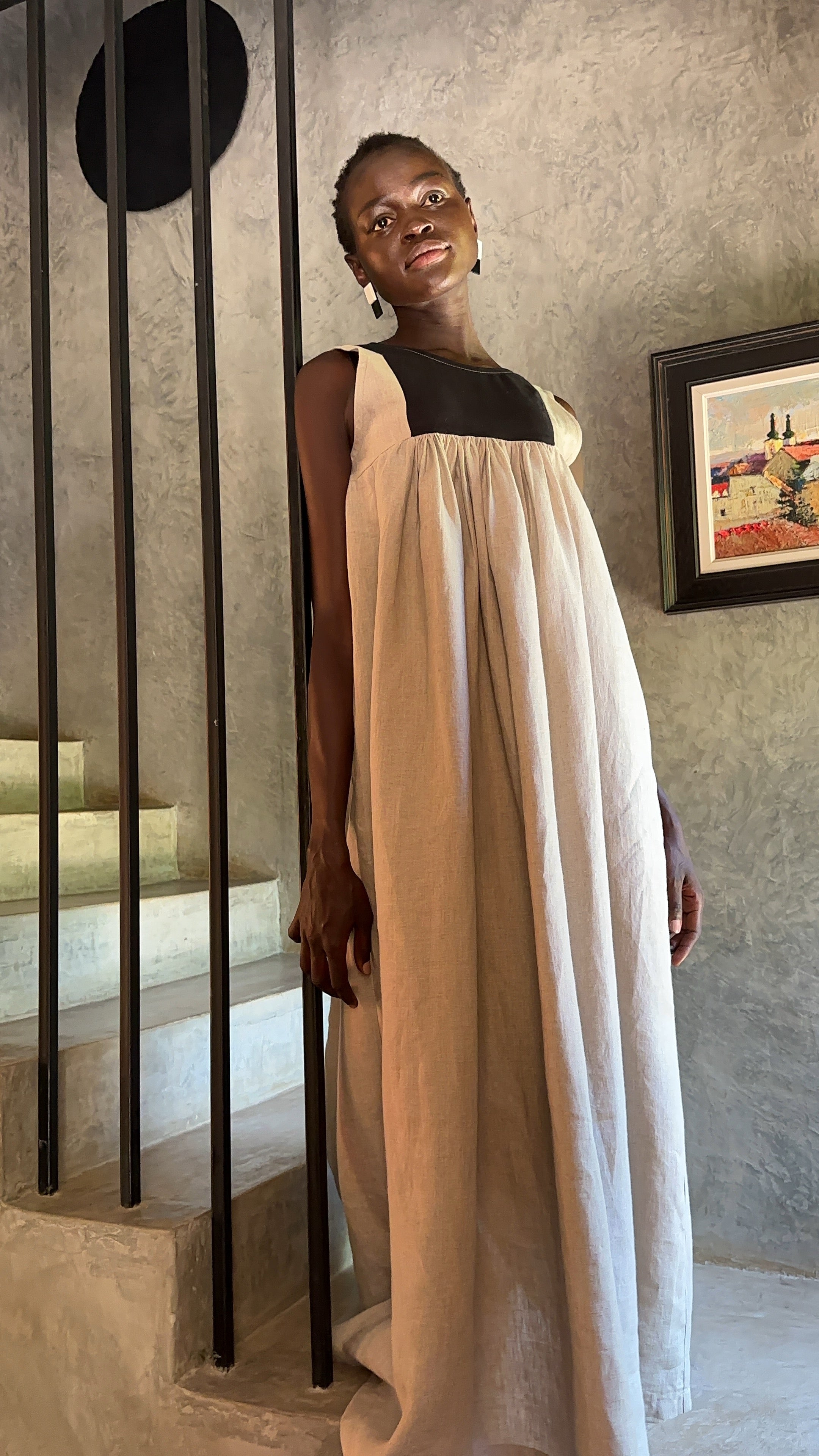 Model wearing Butterfly Linen dress standing on staircase