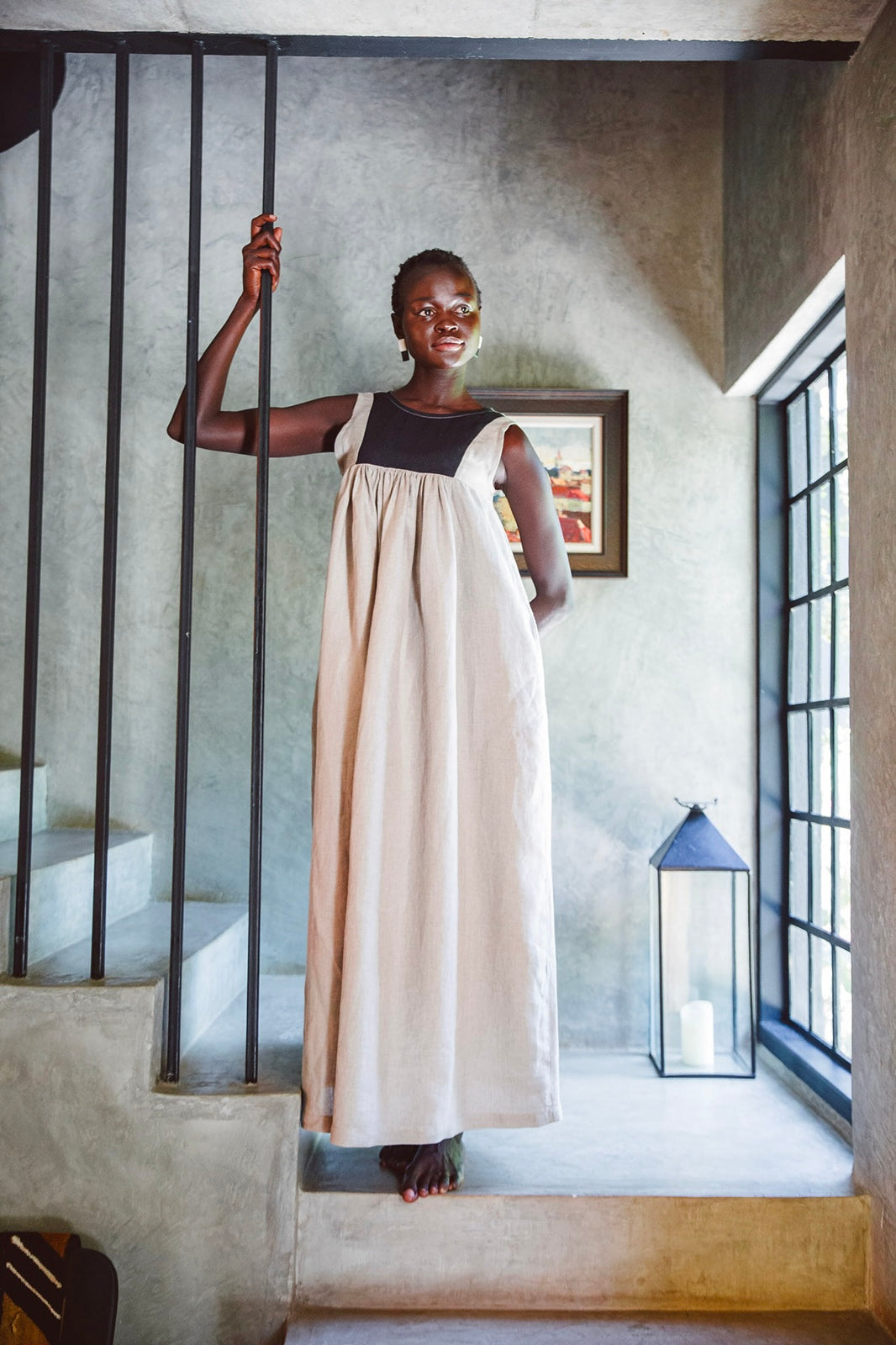 Model wearing Butterfly Linen dress standing on staircase
