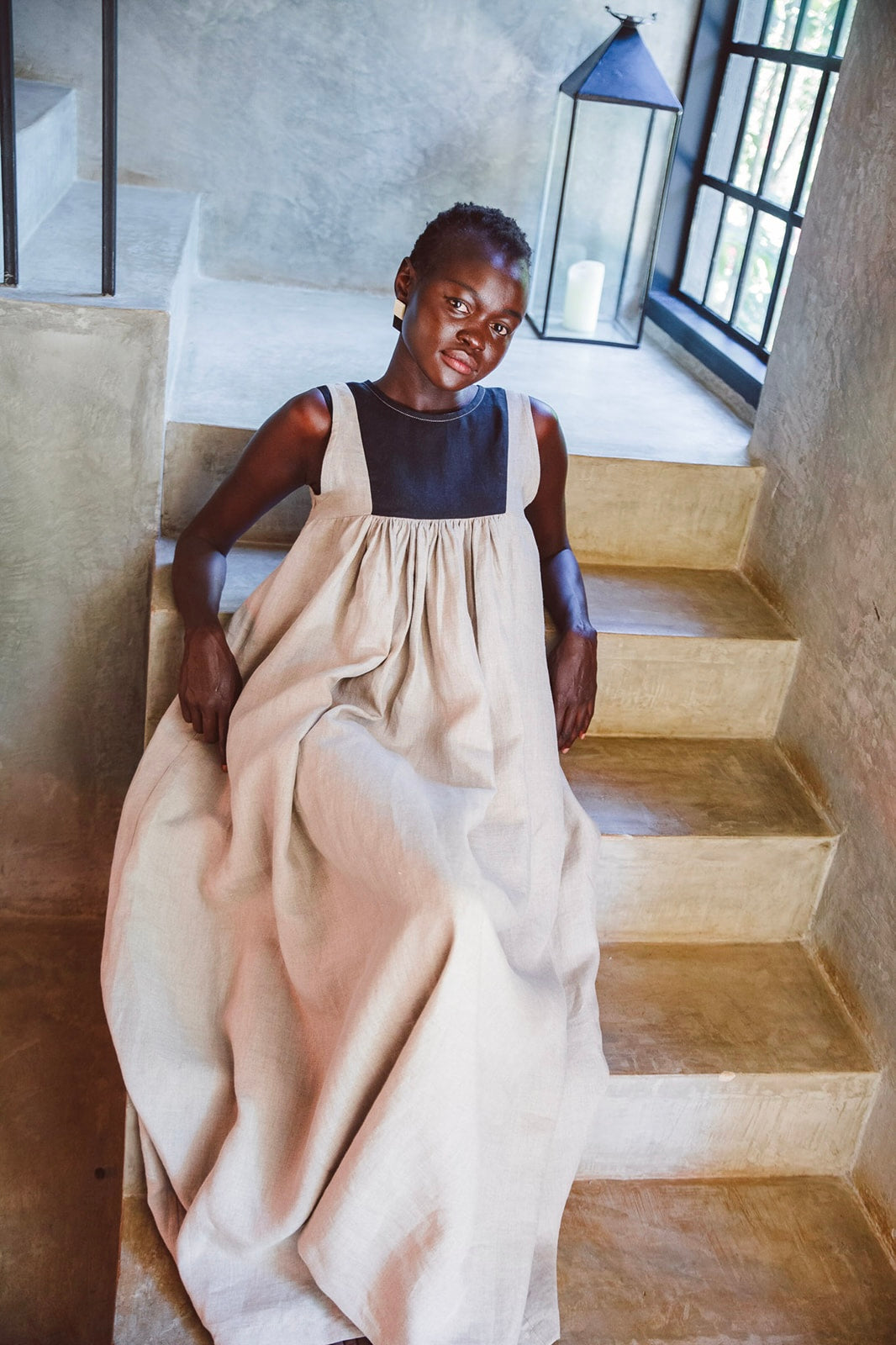 Model wearing Butterfly Linen dress standing on staircase