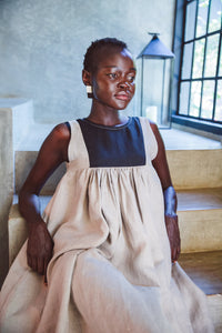 Model wearing Butterfly Linen dress standing on staircase